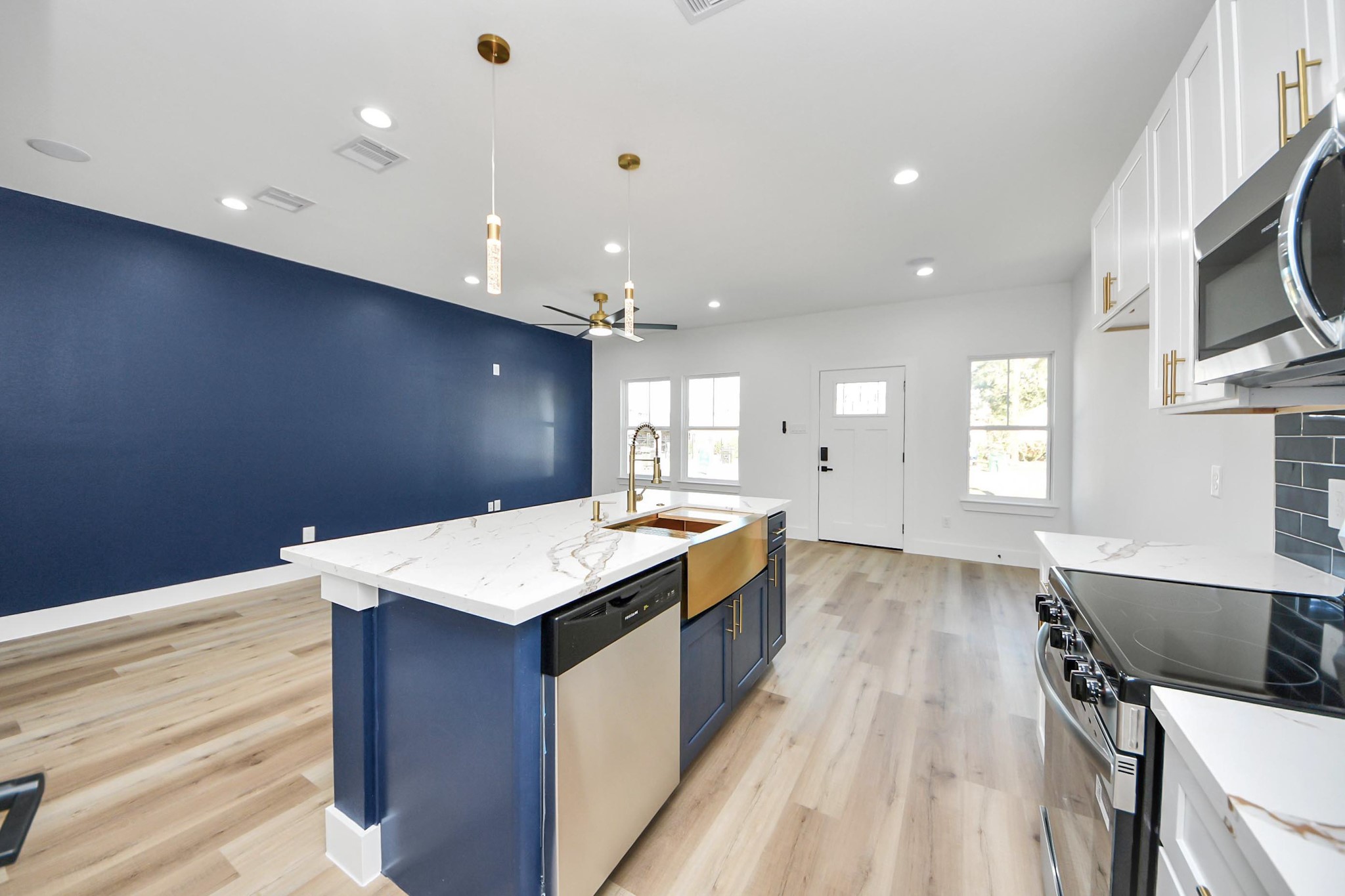 4606 Mallow Street Houston, TX 77051 - Photo 18 of 31 a large kitchen with stainless steel appliances a large counter top a stove a chimney a sink and a refrigerator