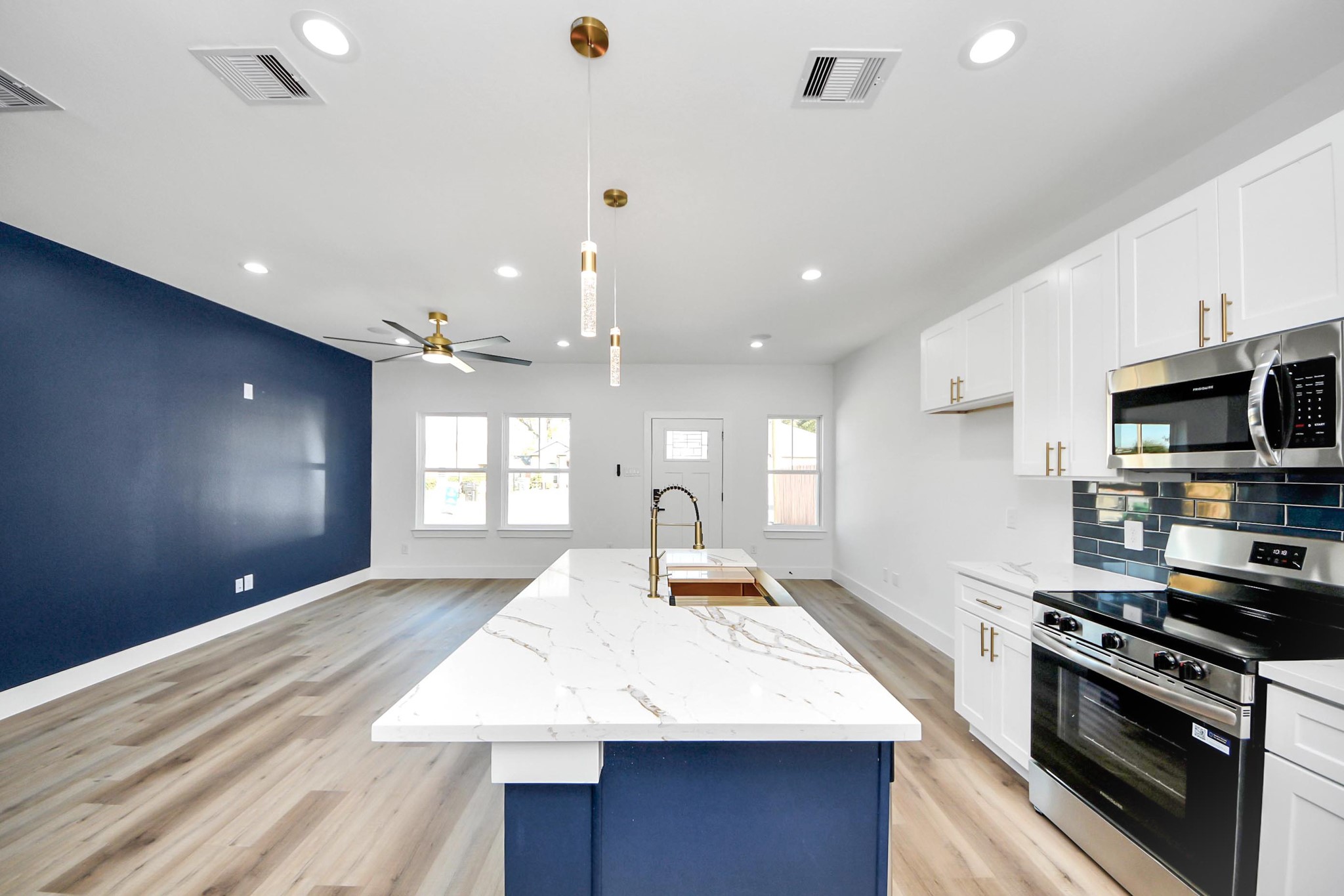 4606 Mallow Street Houston, TX 77051 - Photo 19 of 31 a large kitchen with stainless steel appliances kitchen island granite countertop a stove a sink and a refrigerator