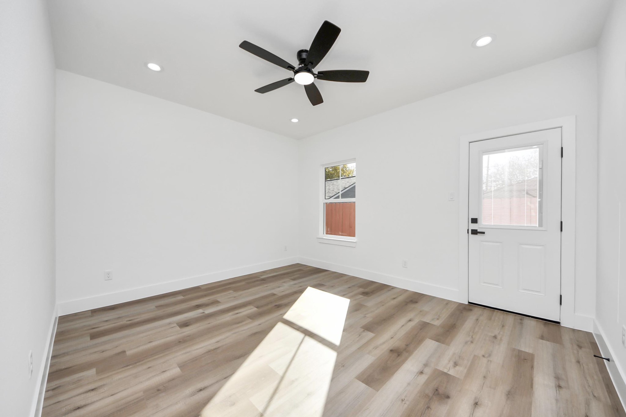 4606 Mallow Street Houston, TX 77051 - Photo 21 of 31 an empty room with wooden floor and ceiling fan