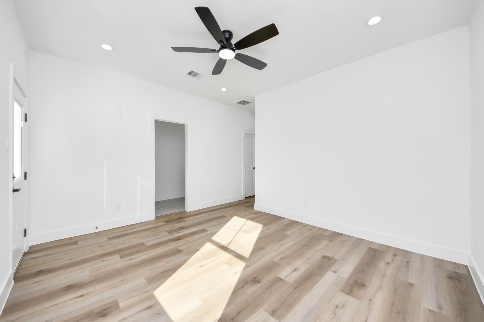 4606 Mallow Street Houston, TX 77051 - Photo 23 of 31 an empty room with wooden floor ceiling fan and window