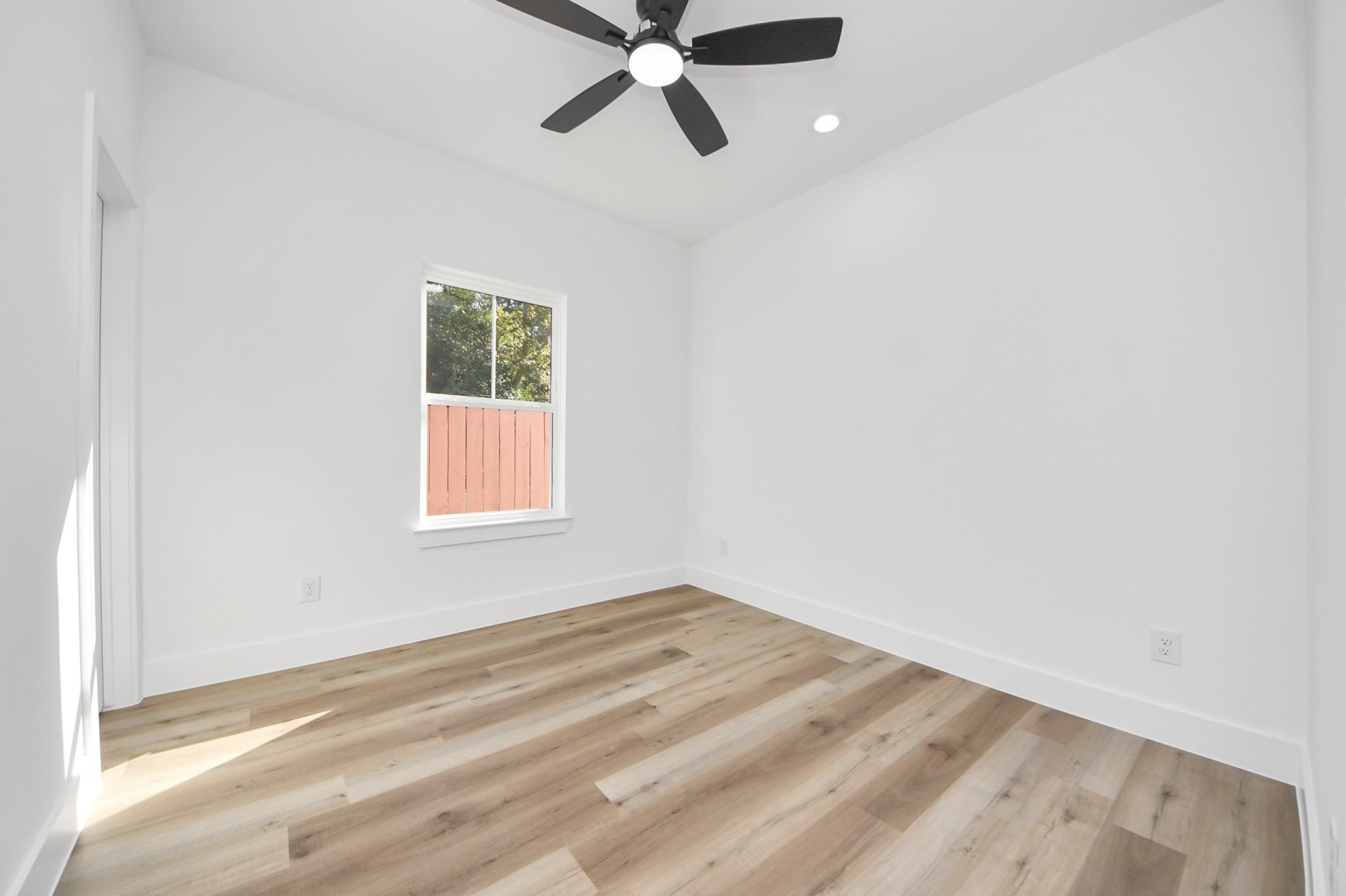 4606 Mallow Street Houston, TX 77051 - Photo 27 of 31 Secondary bedroom features a large window and ceiling fan.