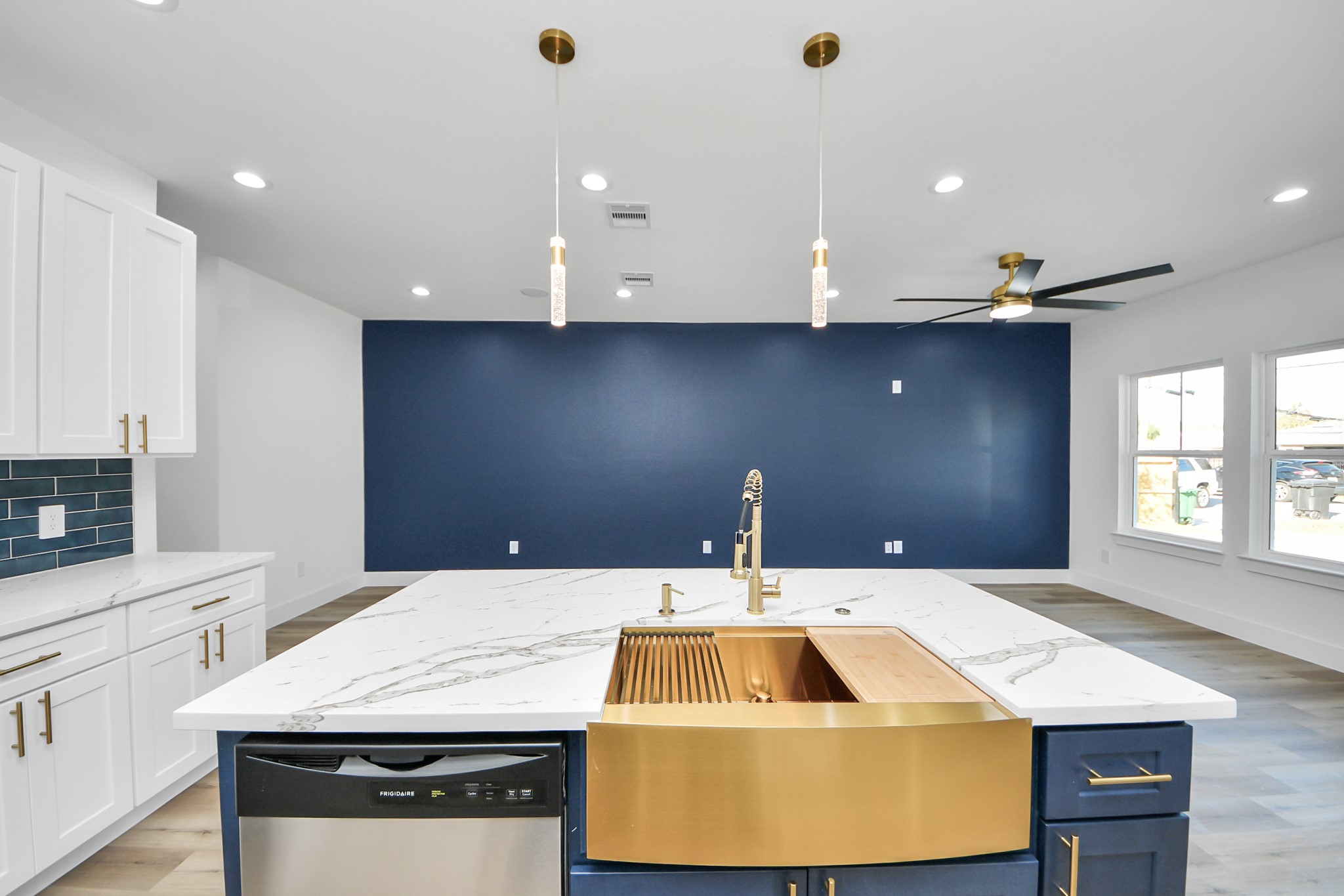 4606 Mallow Street Houston, TX 77051 - Photo 3 of 31 This modern kitchen features a large island with a luxurious countertop and a stylish gold sink.