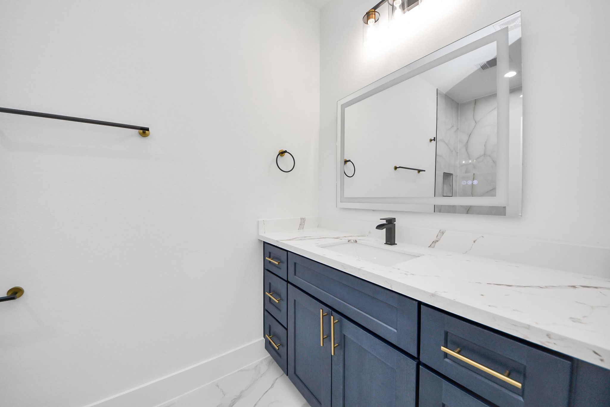 4606 Mallow Street Houston, TX 77051 - Photo 5 of 31 a bathroom with a sink and a mirror