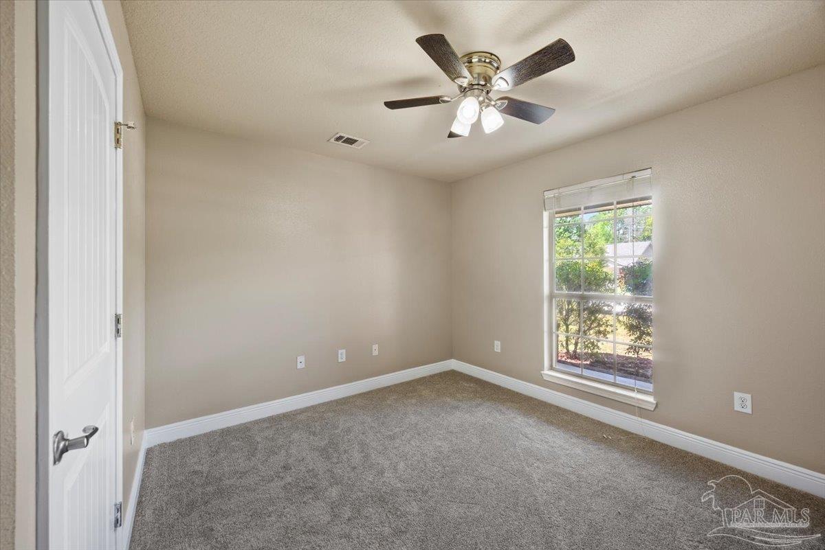 4015 Berry Circle Pace, FL 32571 - Photo 29 of 48 an empty room with windows and fan