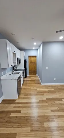 a view of kitchen and empty room