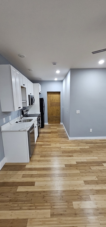 118 Winthrop Street, Unit 2 Boston, MA 02119 - Photo 3 of 7 a view of kitchen and empty room