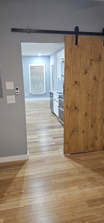 118 Winthrop Street, Unit 2 Boston, MA 02119 - Photo 4 of 7 a view of a hallway with wooden floor and cabinet