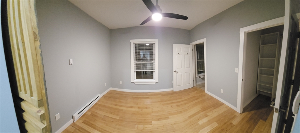 118 Winthrop Street, Unit 2 Boston, MA 02119 - Photo 6 of 7 a view of an empty room with wooden floor and a window