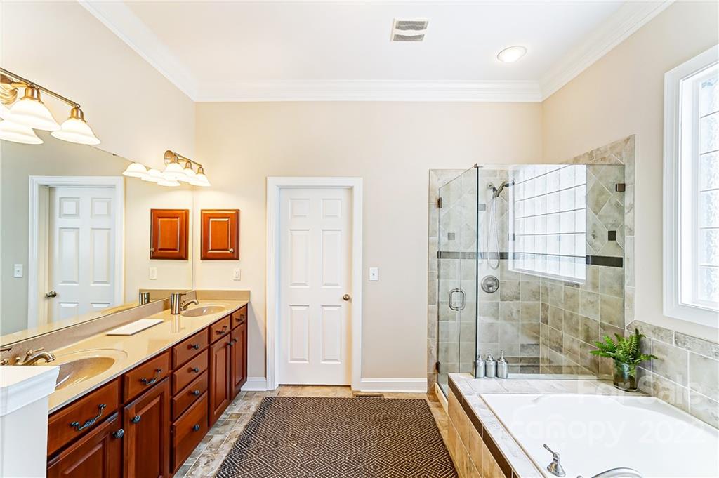 146 Mills Lane Fort Mill, SC 29708 - Photo 31 of 48 a spacious bathroom with a tub sink shower and mirror