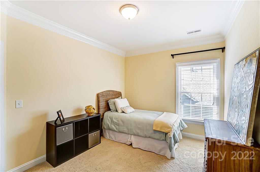 146 Mills Lane Fort Mill, SC 29708 - Photo 38 of 48 a bedroom with a bed and wooden floor