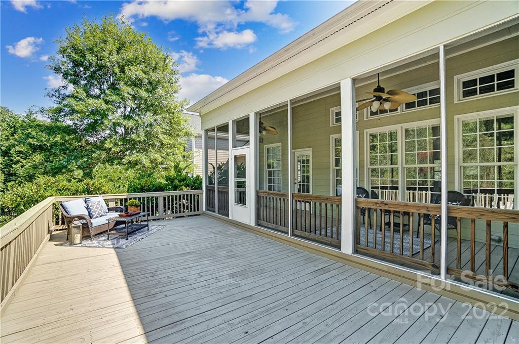 146 Mills Lane Fort Mill, SC 29708 - Photo 45 of 48 a porch with seating space and trees in the background