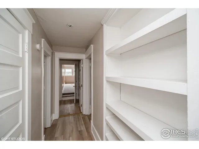 a view of hallway with wooden floor
