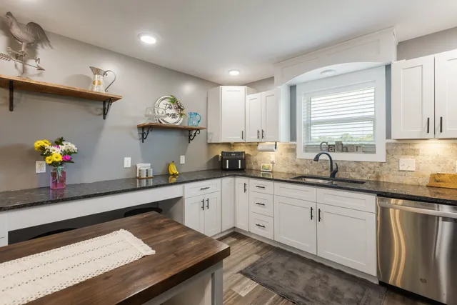 a living room with furniture a flat screen tv and a large window
