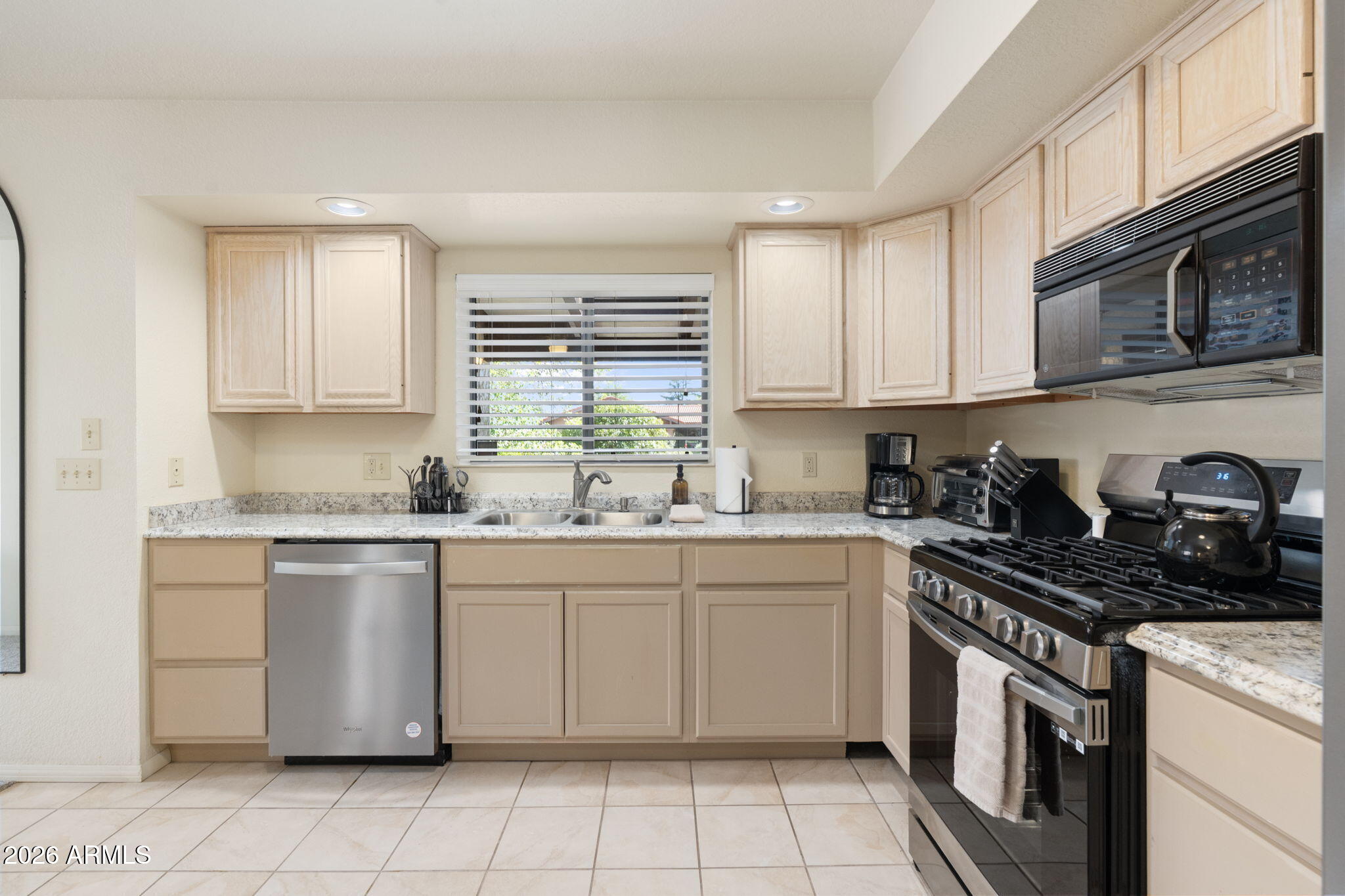 615 Jordan Road Sedona, AZ 86336 - Photo 14 of 82 a kitchen with granite countertop cabinets stainless steel appliances a sink and a window