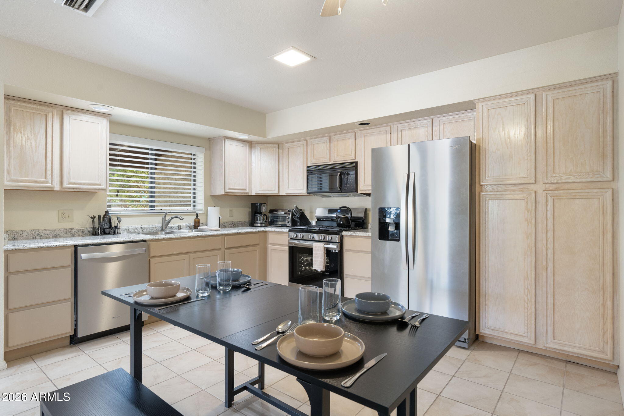 615 Jordan Road Sedona, AZ 86336 - Photo 17 of 82 a kitchen with stainless steel appliances granite countertop a stove a refrigerator a sink a dining table and chairs
