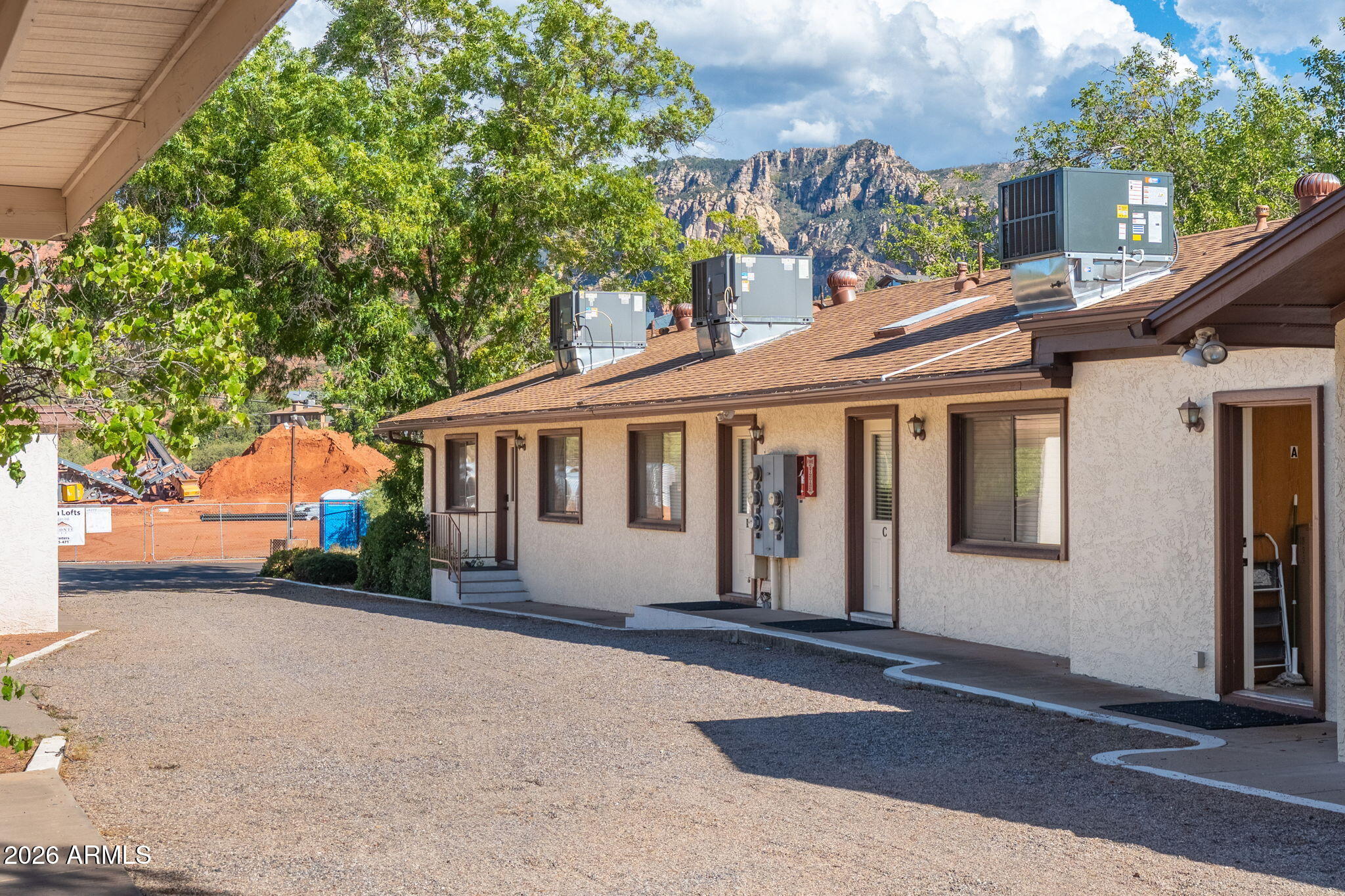 615 Jordan Road Sedona, AZ 86336 - Photo 2 of 88 a front view of a house with a garden and trees