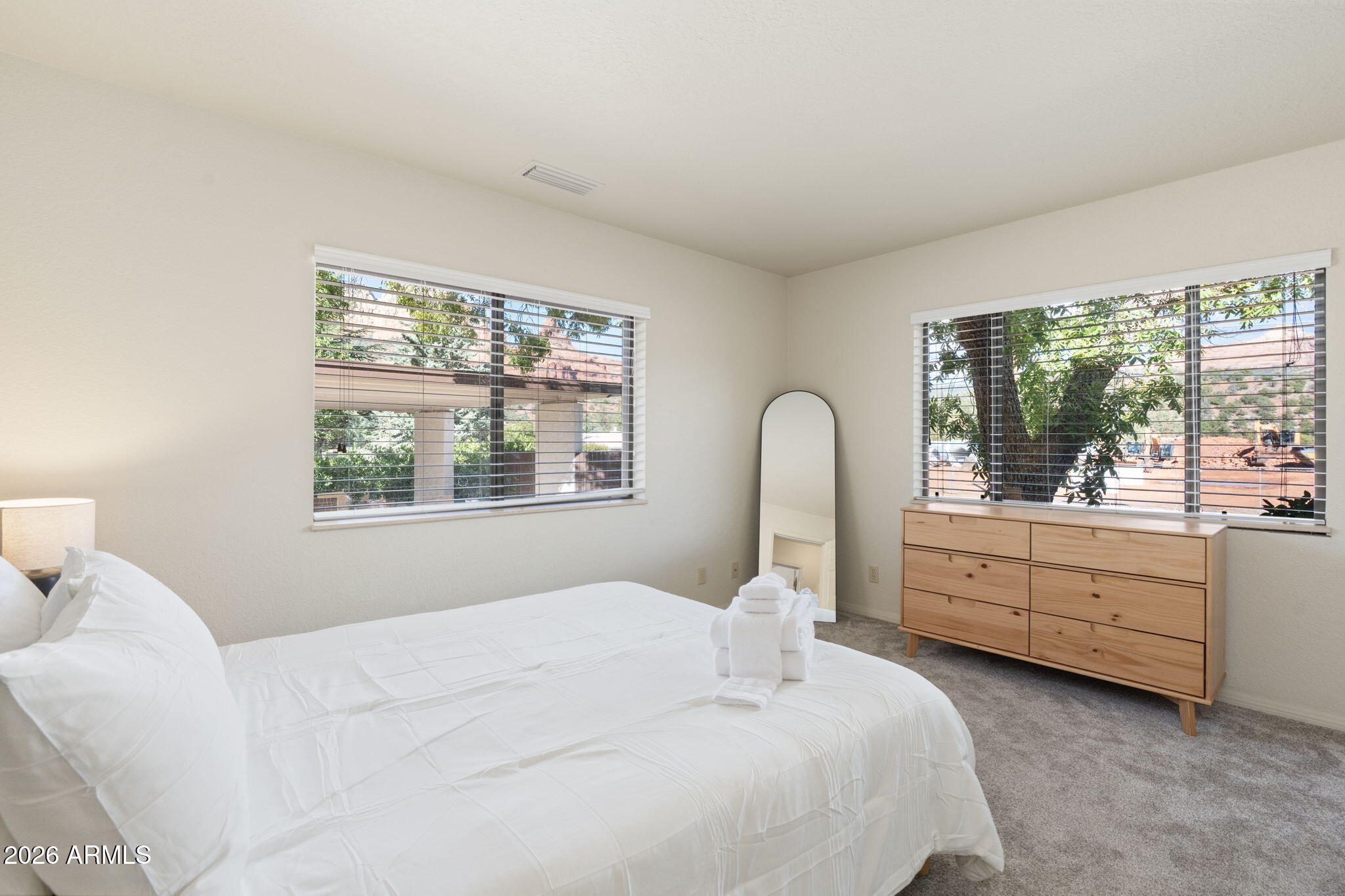 615 Jordan Road Sedona, AZ 86336 - Photo 21 of 82 a bedroom with a bed and a large window