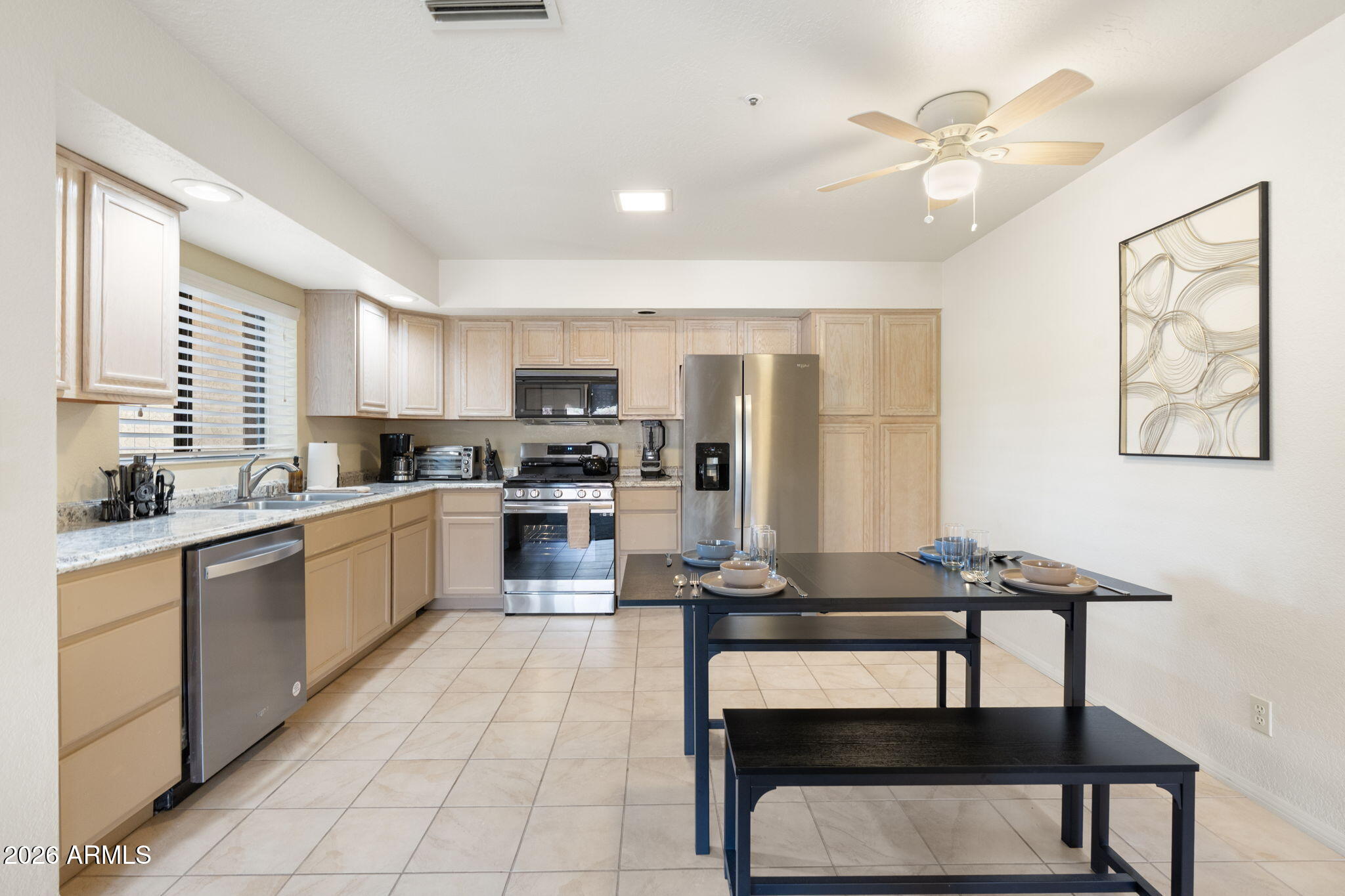 615 Jordan Road Sedona, AZ 86336 - Photo 23 of 88 a kitchen with a dining table chairs stainless steel appliances and cabinets