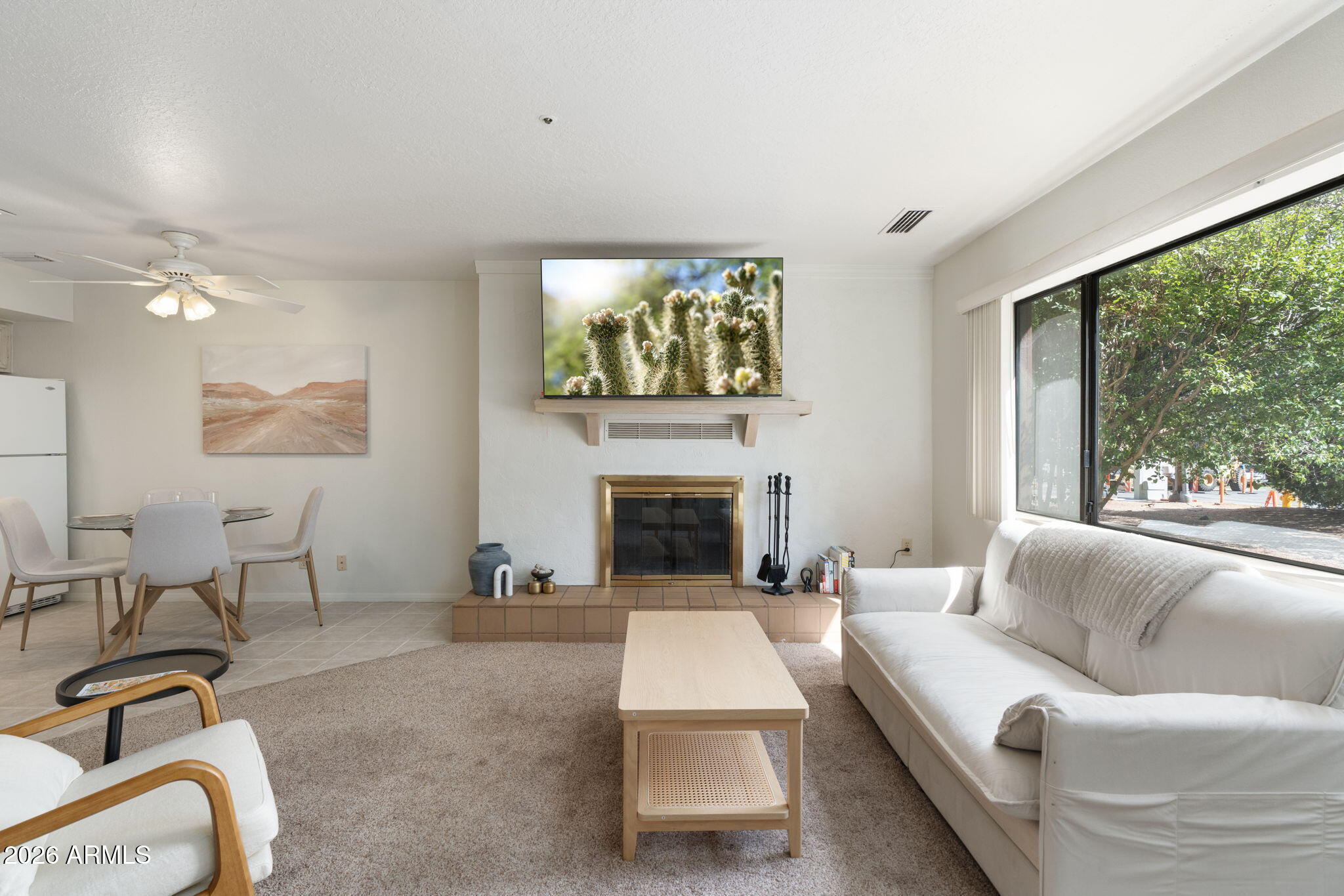 615 Jordan Road Sedona, AZ 86336 - Photo 32 of 82 a living room with furniture a fireplace and a floor to ceiling window
