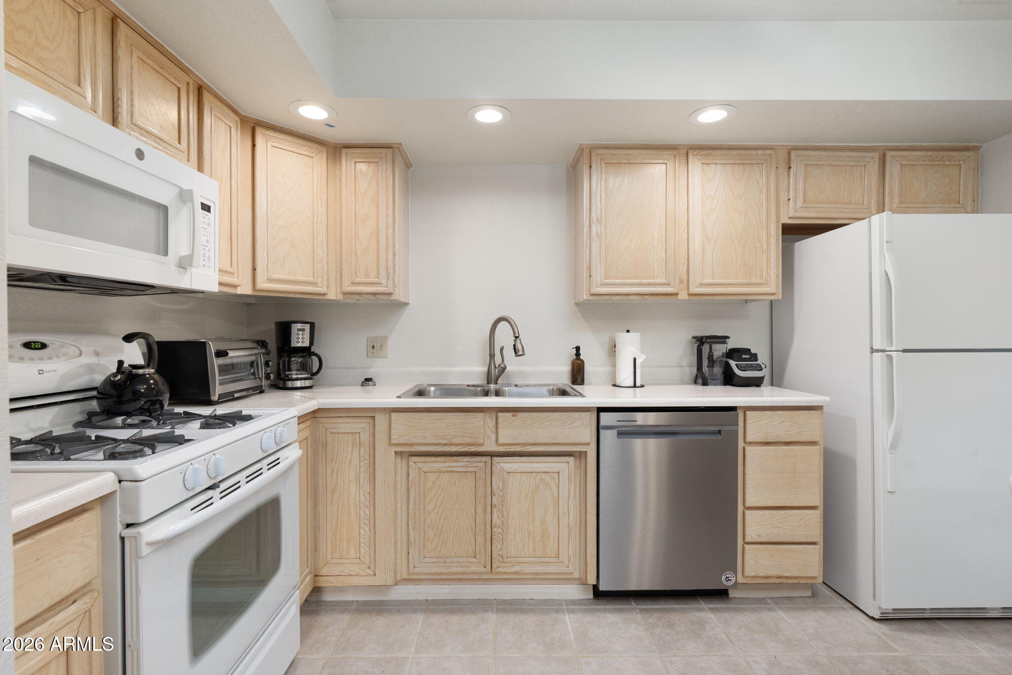 615 Jordan Road Sedona, AZ 86336 - Photo 35 of 82 a kitchen with white cabinets and white appliances