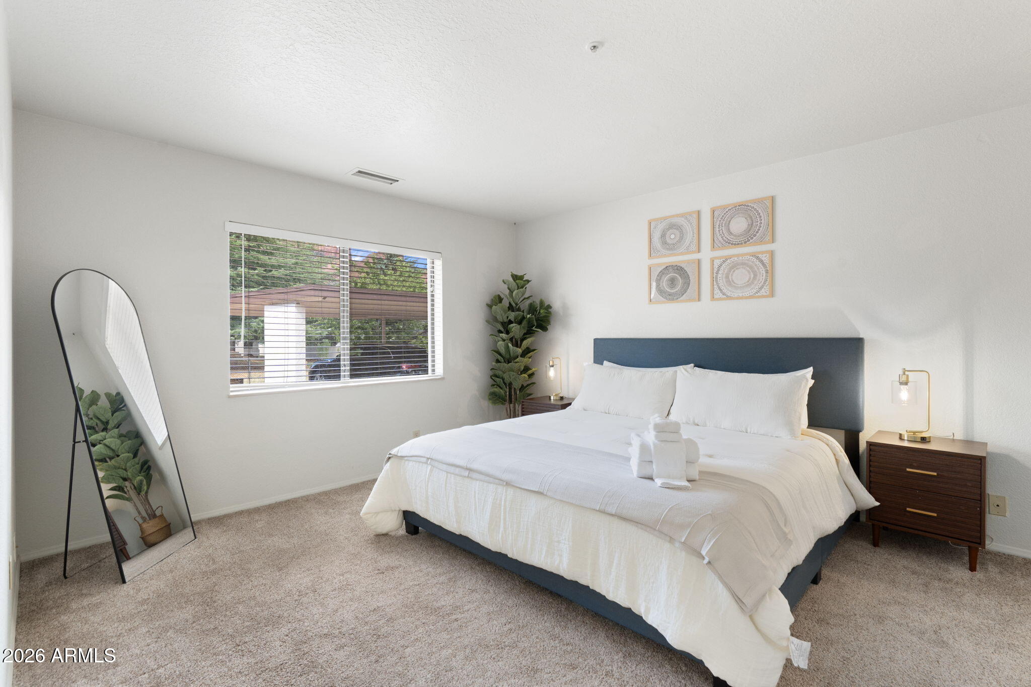615 Jordan Road Sedona, AZ 86336 - Photo 40 of 82 a bedroom with a bed a couch and a window