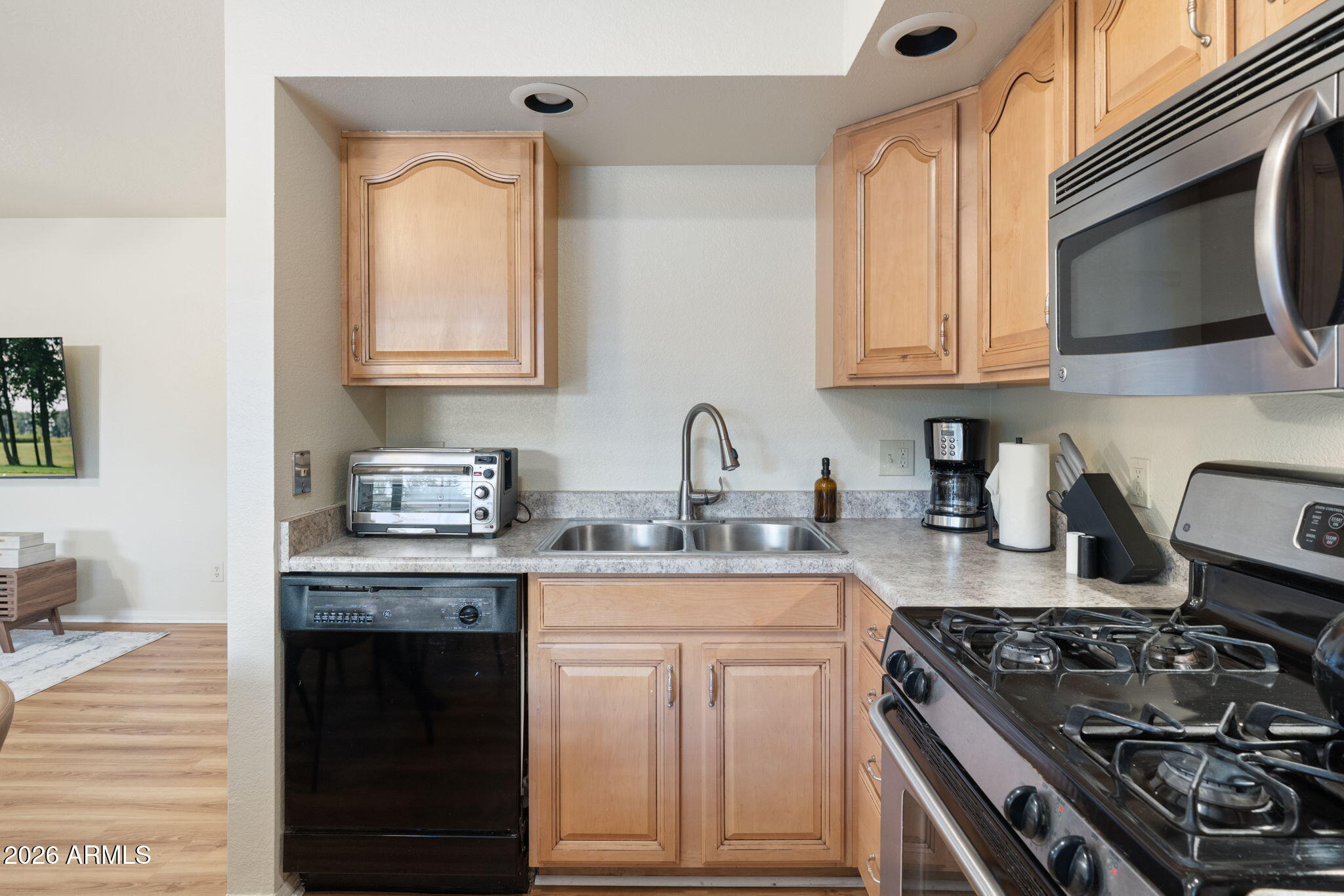 615 Jordan Road Sedona, AZ 86336 - Photo 51 of 82 a kitchen with stainless steel appliances granite countertop a stove a sink dishwasher and cabinets with wooden floor