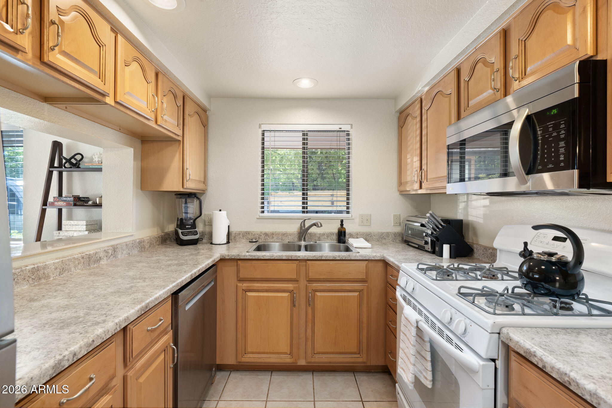 615 Jordan Road Sedona, AZ 86336 - Photo 72 of 82 a kitchen with a sink stove top oven and cabinets