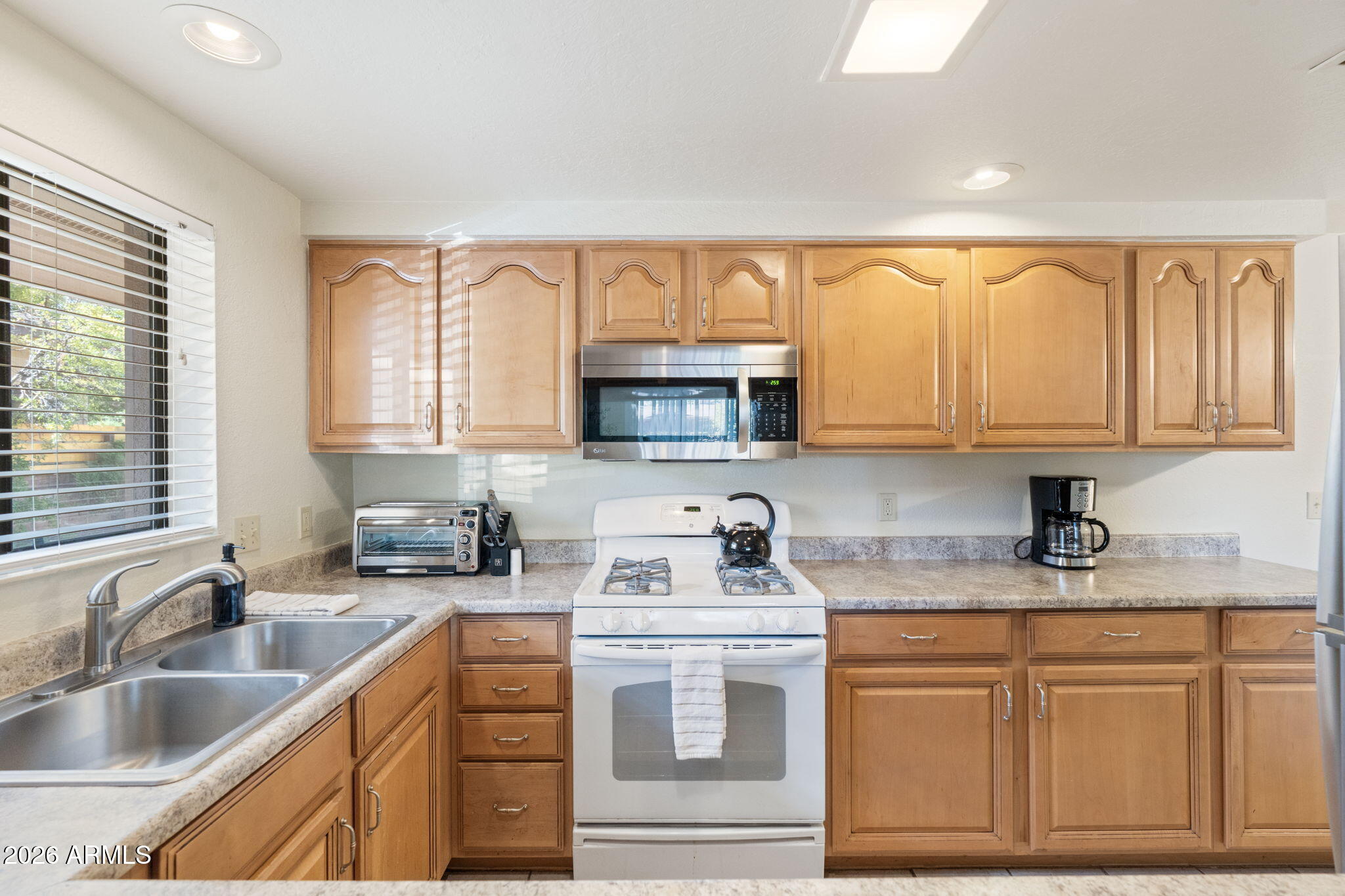 615 Jordan Road Sedona, AZ 86336 - Photo 73 of 82 a kitchen with granite countertop a sink cabinets and window