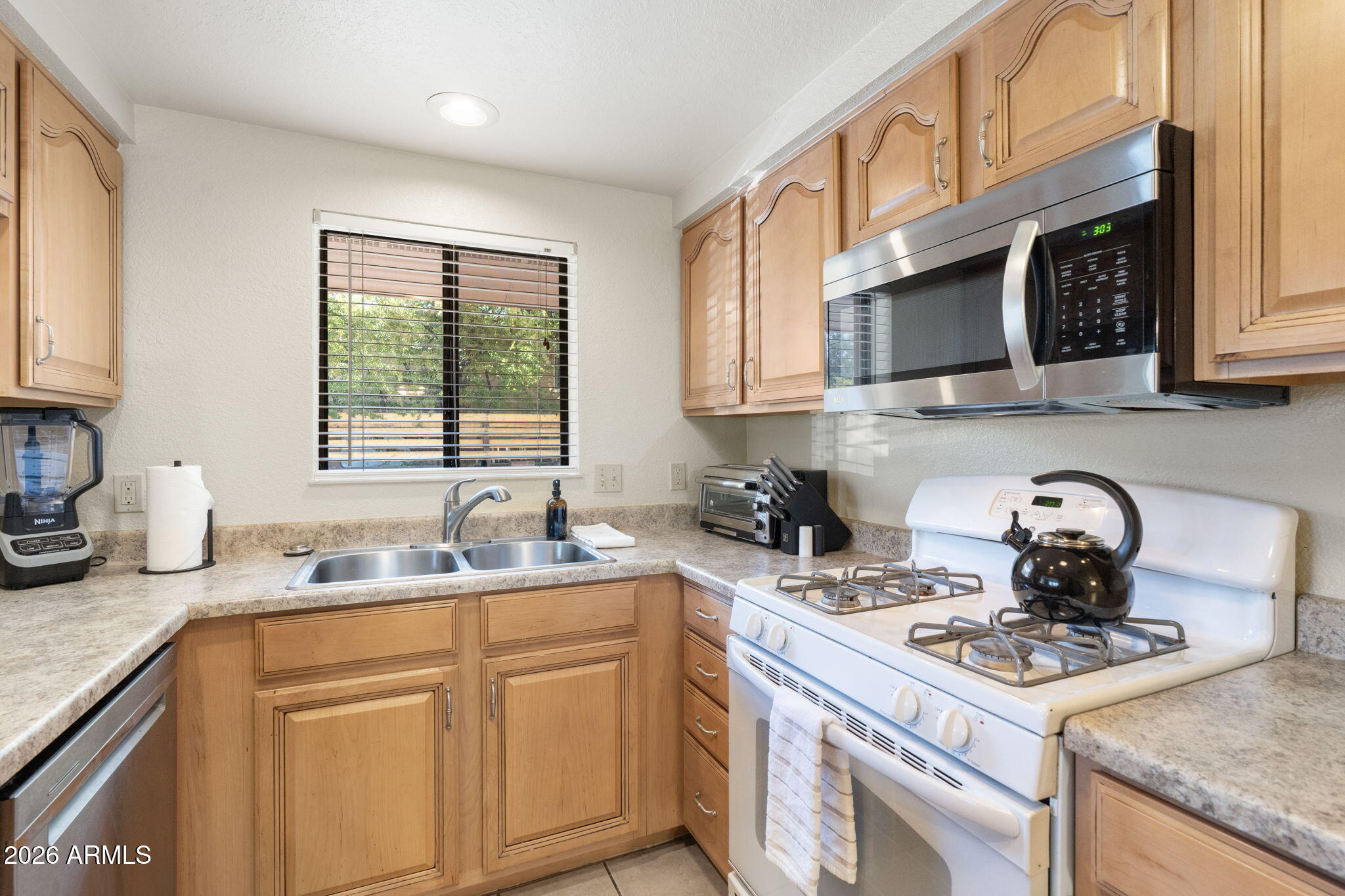 615 Jordan Road Sedona, AZ 86336 - Photo 80 of 88 a kitchen with stainless steel appliances granite countertop a sink stove cabinets and a window