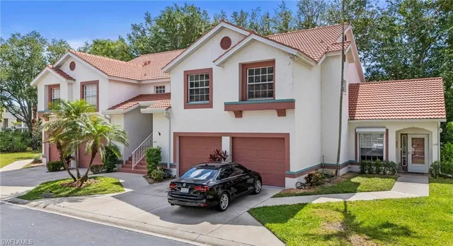 a car parked in front of a white house