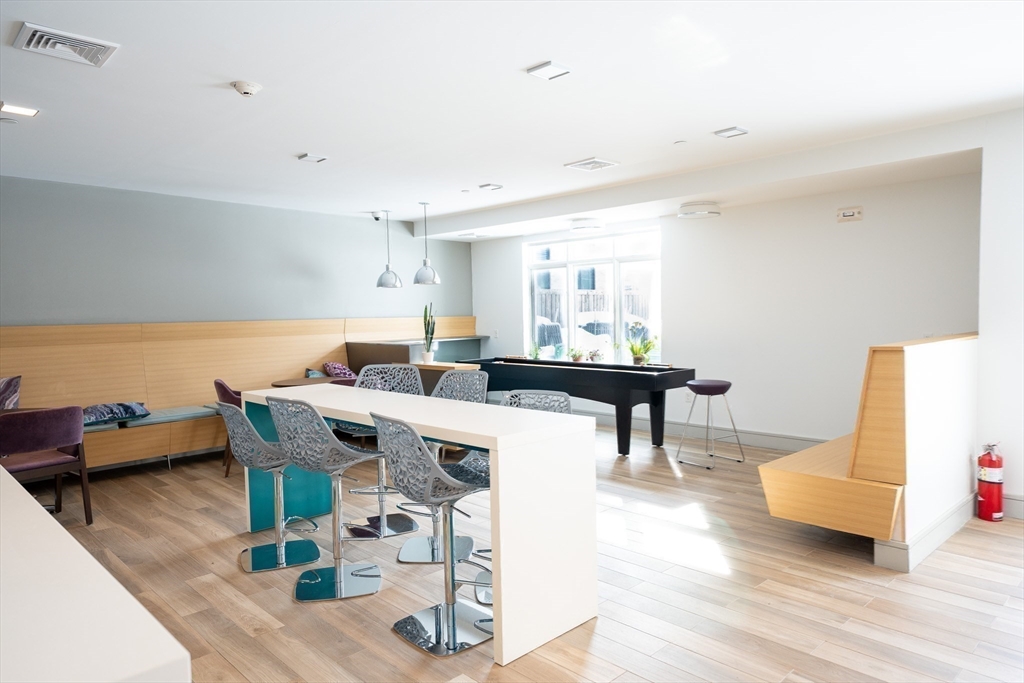 180 Telford Street, Unit 605 Boston, MA 02135 - Photo 14 of 24 a living room with furniture and a table