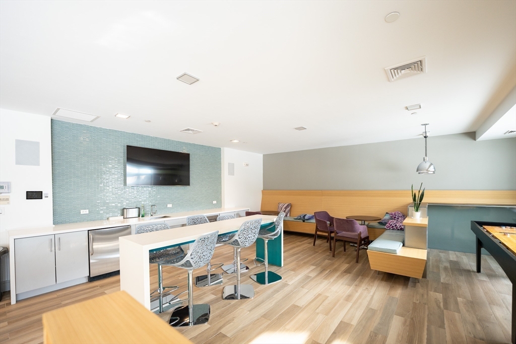 180 Telford Street, Unit 605 Boston, MA 02135 - Photo 17 of 24 a living room with furniture and a flat screen tv