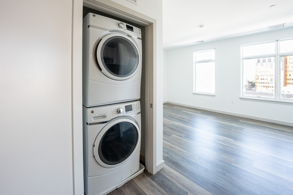 180 Telford Street, Unit 605 Boston, MA 02135 - Photo 6 of 24 a view of a hallway with washer and dryer