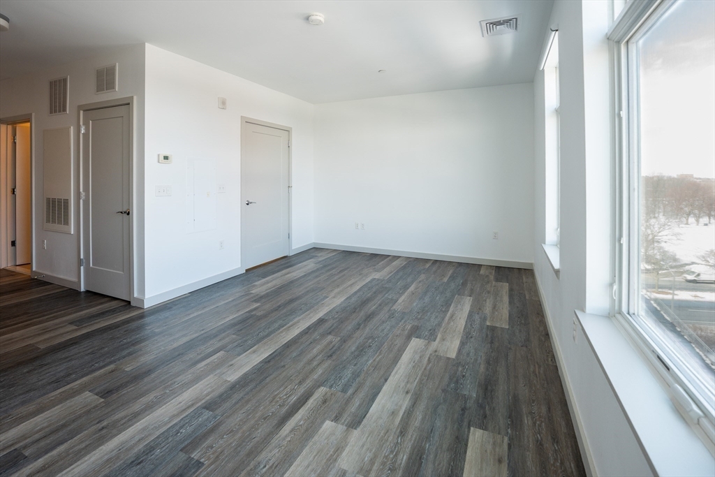 180 Telford Street, Unit 605 Boston, MA 02135 - Photo 7 of 24 a view of wooden floor in a room