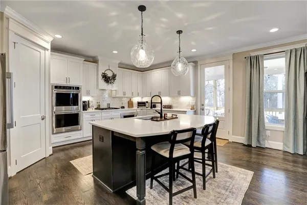a kitchen with granite countertop a white stove top oven and cabinets