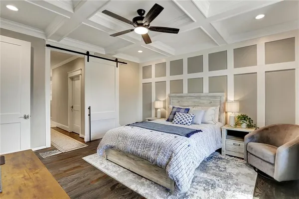 a spacious bedroom with a bed and a chandelier