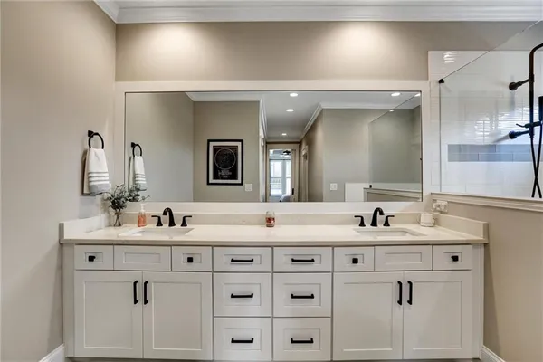 a spacious bedroom with a bed and a flat screen tv