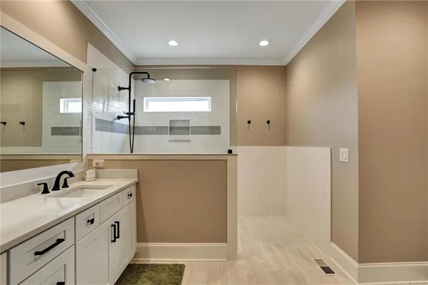 a spacious bathroom with a double vanity sink and a mirror