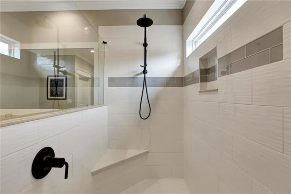a en suite bathroom with a double vanity sink and a mirror