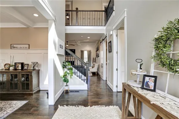 a living room with furniture a wooden floor and a chandelier