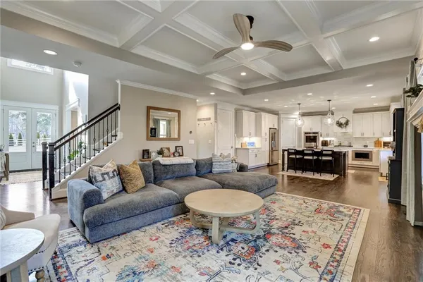 a living room with furniture a rug and a fireplace