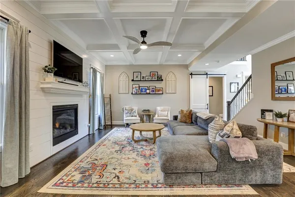 a living room with fireplace furniture and a flat screen tv