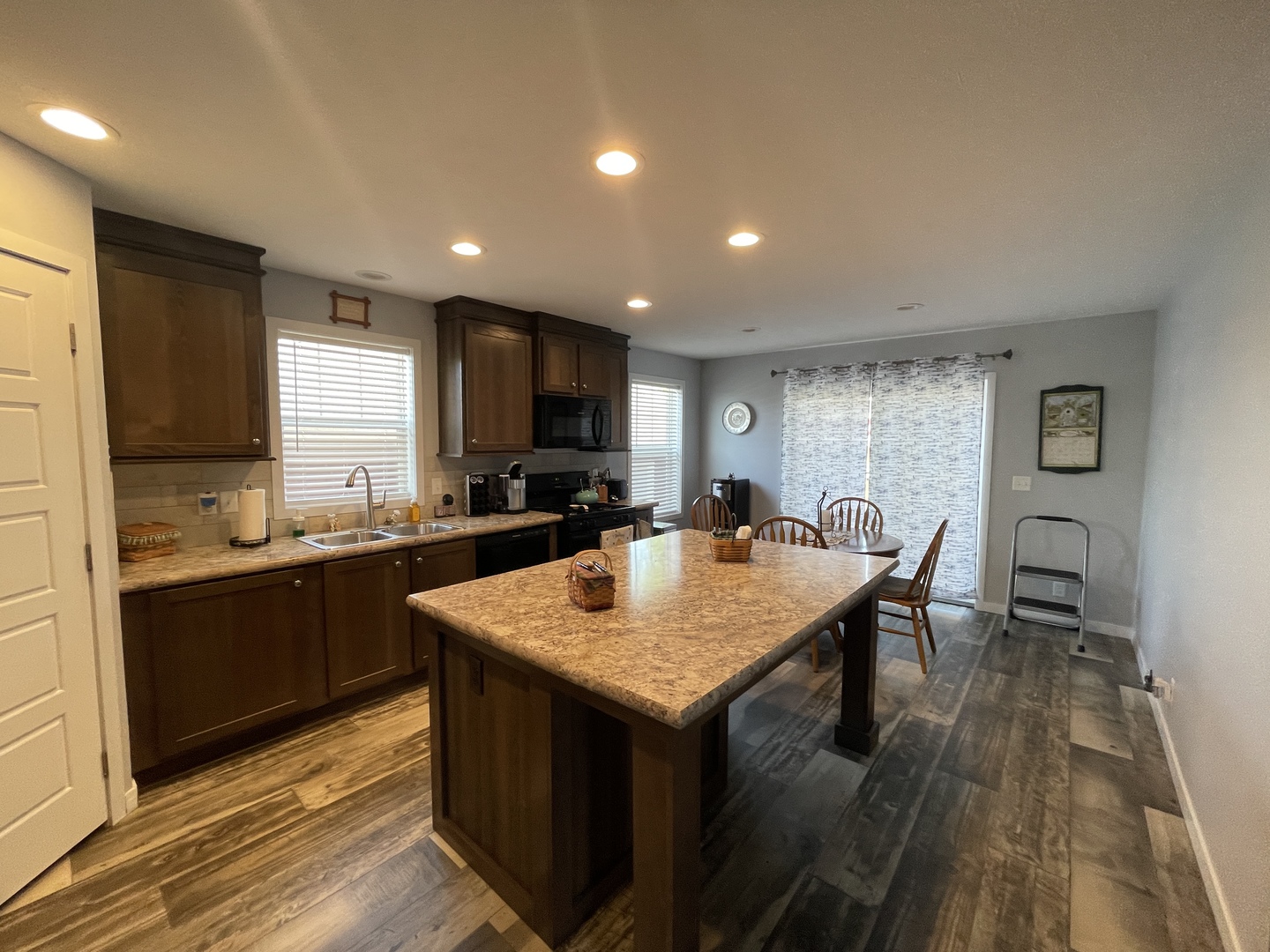 25715 Olympic Drive Monee, IL 60449 - Photo 15 of 19 a kitchen with granite countertop a stove top oven sink and cabinets