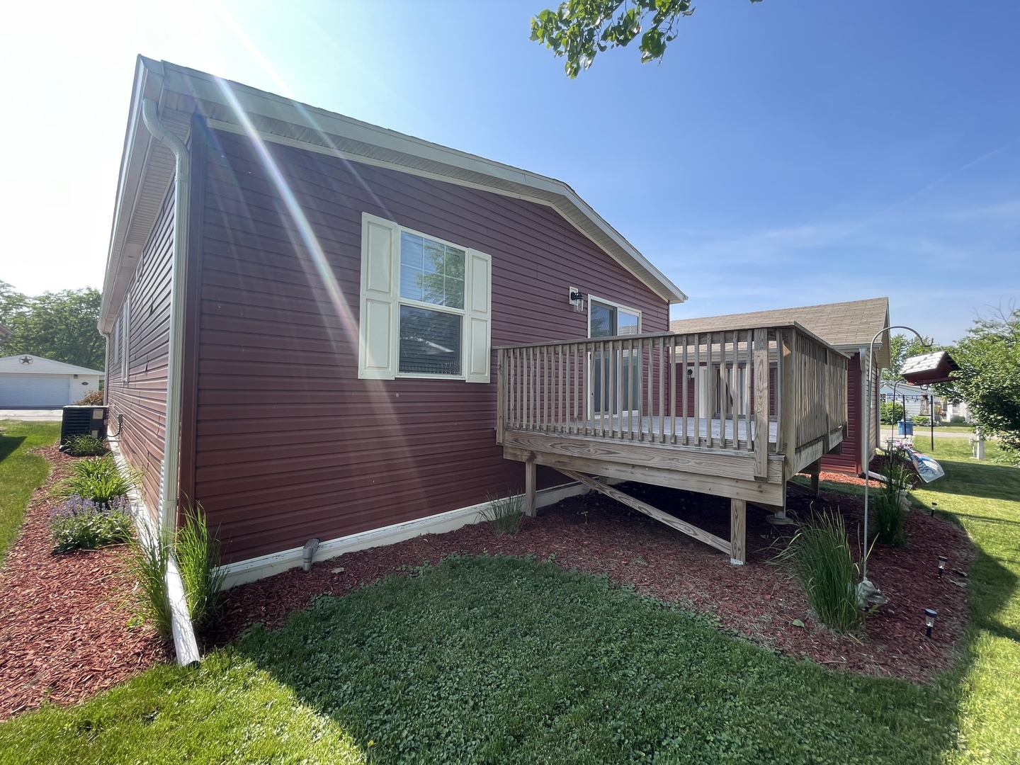 25715 Olympic Drive Monee, IL 60449 - Photo 2 of 19 a backyard of a house with a garden and barbeque oven