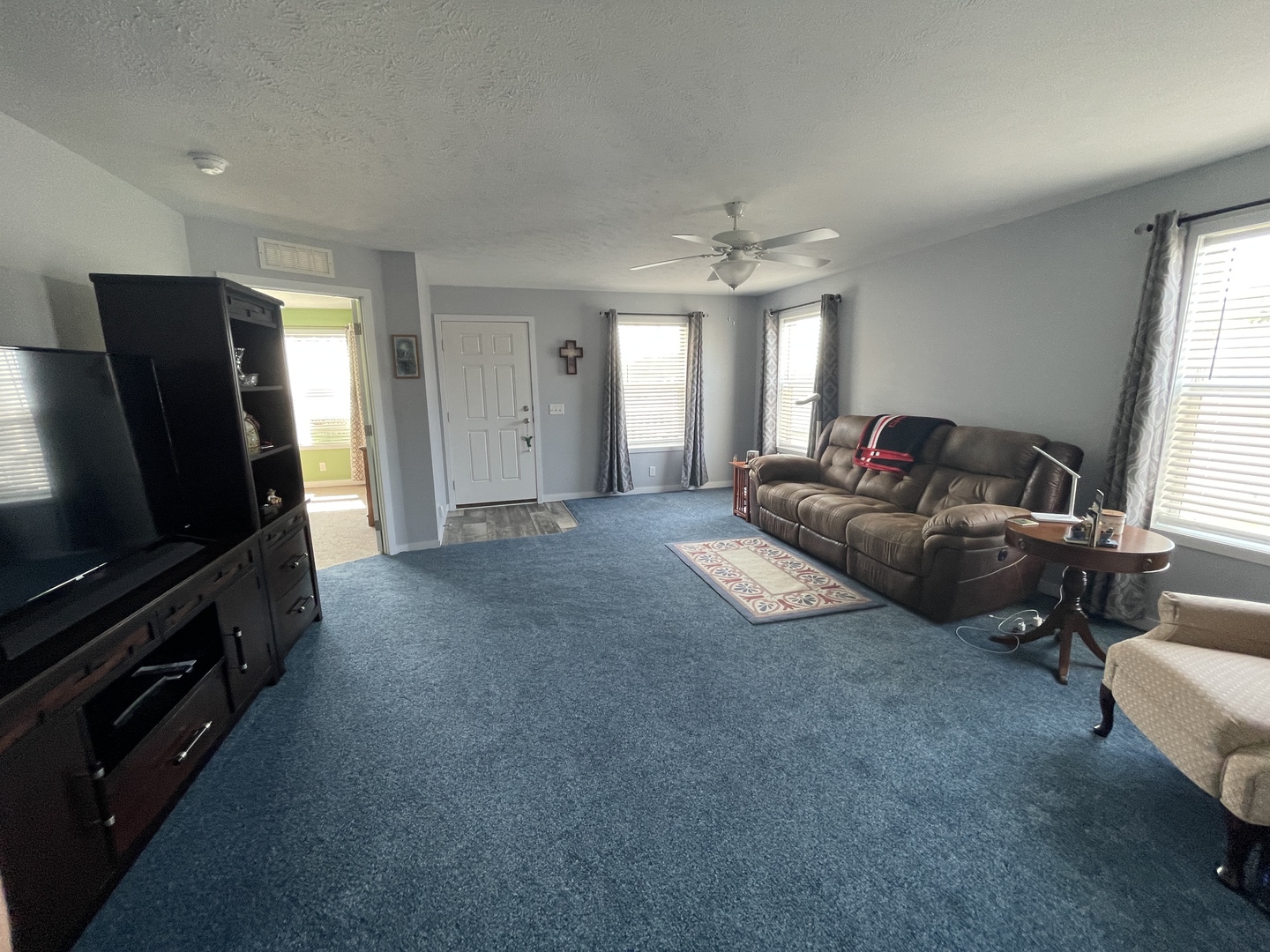 25715 Olympic Drive Monee, IL 60449 - Photo 5 of 19 a living room with furniture and a flat screen tv