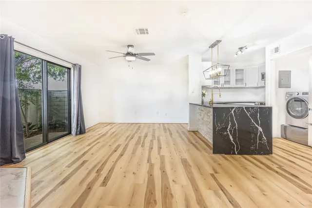 a spacious bedroom with a bed and dresser