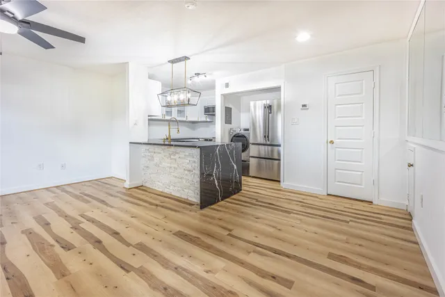 a view of a kitchen counter space and wooden floor