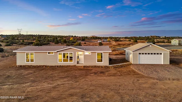 an aerial view of residential houses with yard