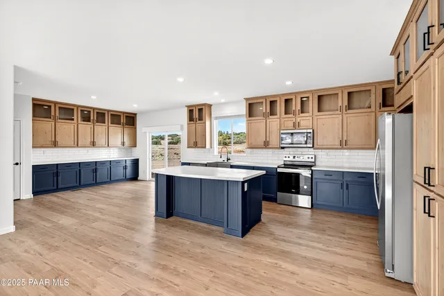 an empty room with windows and ceiling fan