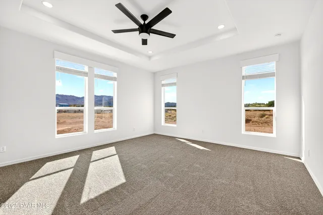 a spacious bedroom with a large bed and a large window